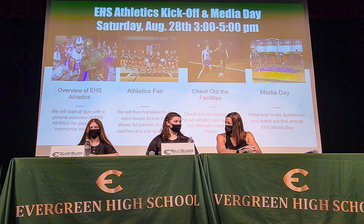Delaney Bollman and Molly Delgado of Evergreen slowpitch softball, along with coach Carrie Urban prepare to answer questions from the media at Evergreen High School’s media day. Photo by Paul Valencia