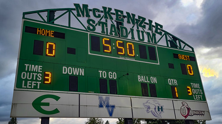 The McKenzie Stadium scoreboard has logos from the four high schools that call the stadium home: Evergreen, Mountain View, Heritage, and Union. Photo by Paul Valencia