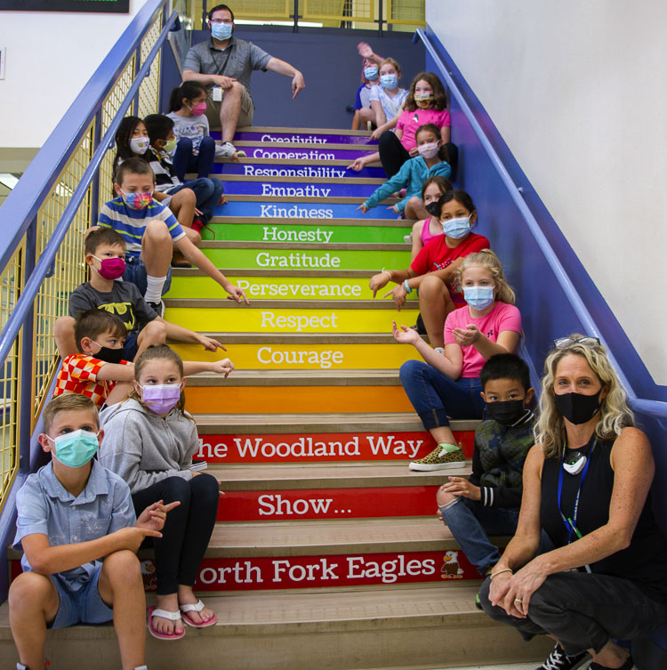 Leadership/SEL Teacher Stacia Aschoff (far right) sits with her leadership class on the stairs of North Fork Elementary School in Woodland. Photo courtesy of Woodland School District