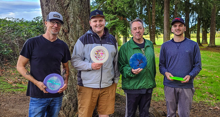 Jason Roland, David Gascon, Bruce Greer, and Louis Braafladt have become friends through disc golf. The community welcomes everyone, they said. Gascon, relatively new to the sport, now organizes tournaments in Clark County. Photo by Paul Valencia