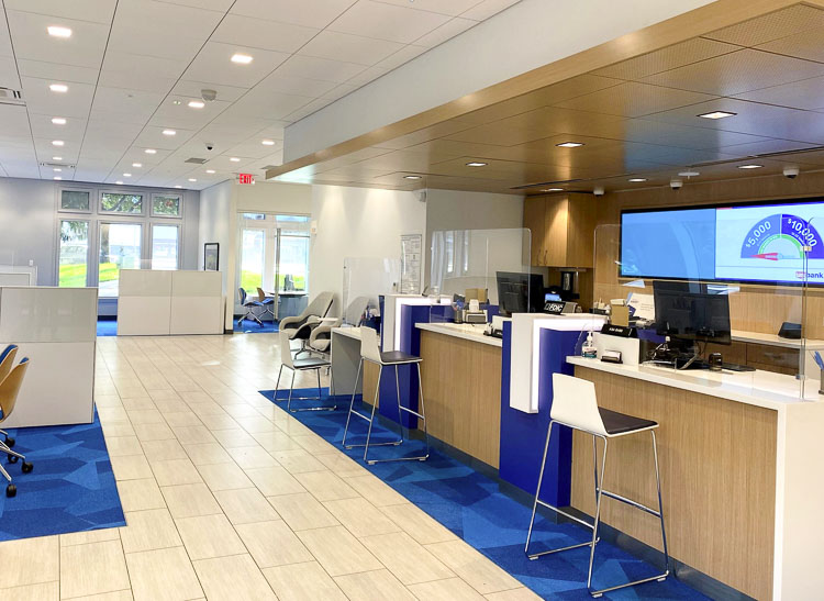 The new branch experience includes bankers equipped with mobile tablets to help customers throughout the many spaces of the branch, including customer support stations that provide space for one-on-one conversations and replace the common teller lines. Photo courtesy U.S. Bank