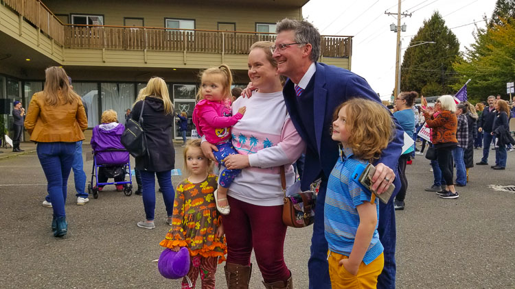 One of many families give hugs and pose for pictures with Scott Miller. They gathered to offer support and encouragement to Miller, his staff, and family. Photo by John Ley