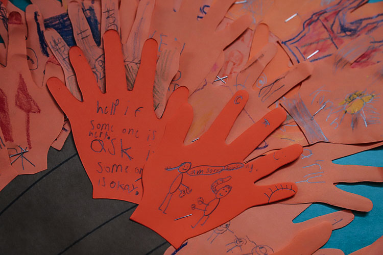 Students wrote or drew their ideas of ways they could help others on the orange handprint cutouts. Photo courtesy Ridgefield School District