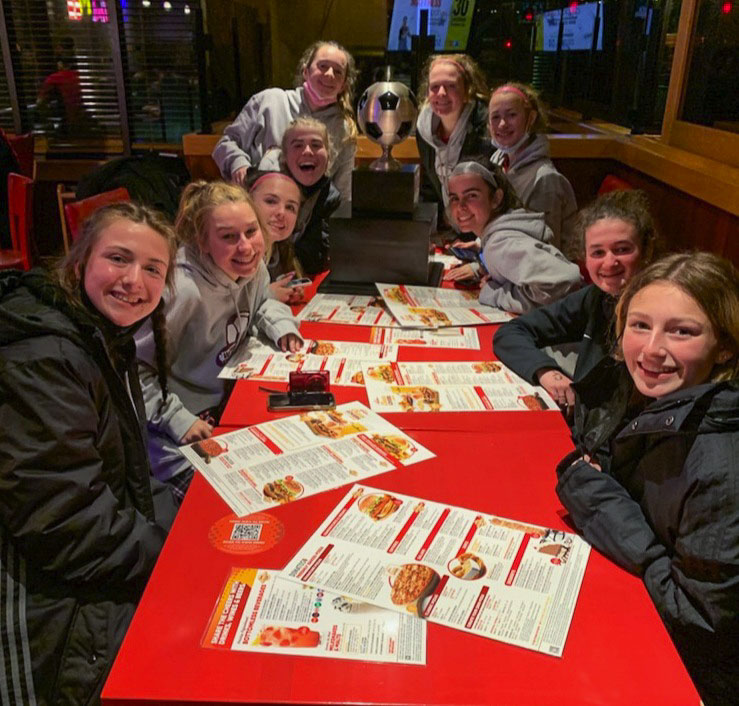 Everything tastes better when dining with the state championship trophy. Photo courtesy Camas girls soccer team