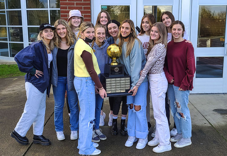 The Columbia River volleyball team showe off the state championship trophy in front of the school this week. Photo by Paul Valencia