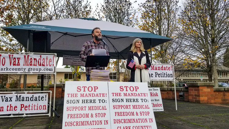 Rob Anderson and Rep. Vicki Kraft are in front of a crowd of roughly 50 Clark County citizens. They support medical freedom and oppose the vaccine mandates imposed at both the federal and state levels. They applauded the people for collecting over 11,000 signatures on the mini initiative petition that was submitted to the Clark County Elections Department office a short time later. Photo by John Ley