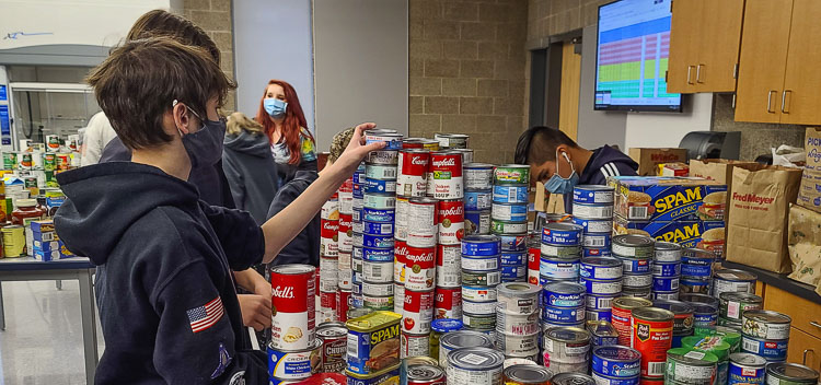 Hockinson Middle School students stack cans as they help in the annual community food drive. Photo by Paul Valencia