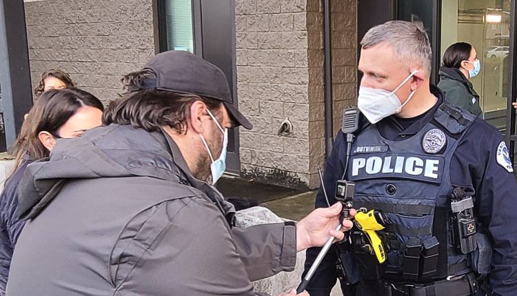 Ilia Botvinnik talks to the media about the use of body cameras as well as cameras in his police car. Botvinnik said he noticed a car run a stop sign on Wednesday, pressed a button, and the traffic violation was captured on video, too. Photo by Paul Valencia