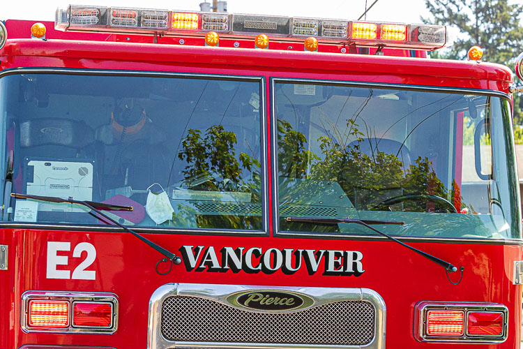 Members of the Vancouver Fire Department saved a woman from a house fire Sunday morning.