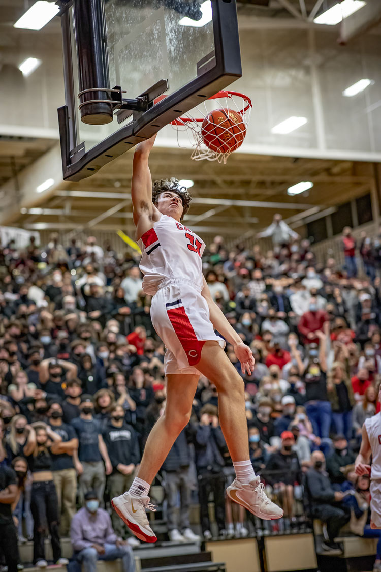 Camas’ Stephen Behil with the dunk, and notice the crowd in the background. The gym at Camas High School was packed Tuesday night and fans witnessed the Papermakers beat Union for a share of the league title. Photo courtesy Heather Tianen