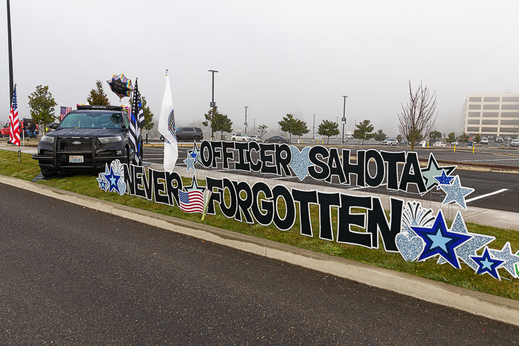 A tribute to Vancouver Police Officer Donald Sahota was displayed outside the Memorial Service Tuesday at the ilani Resort Casino. Photo by Mike Schultz