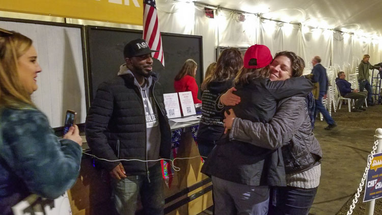 Harly Thompson (red hat) gets a hug from a friend after making comments via phone, to the County Council. She is a nurse who is unemployed due to the vaccine mandates. She continues to help people dealing with the symptoms of COVID-19. Photo by John Ley