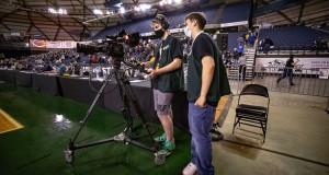 Derrick Ruggles is behind the camera, and getting help from Ethan Reyes. The two students from Columbia River High School were part of the Vancouver-based production crew that broadcast the state championship basketball games in the Tacoma Dome last week. Photo by Heather Tianen