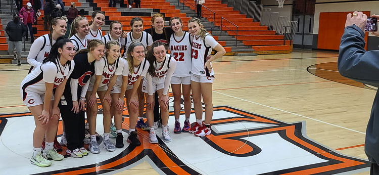 The Camas girls basketball team was all smiles after winning an elimination game Friday night to advance to the Tacoma Dome. Photo by Paul Valencia