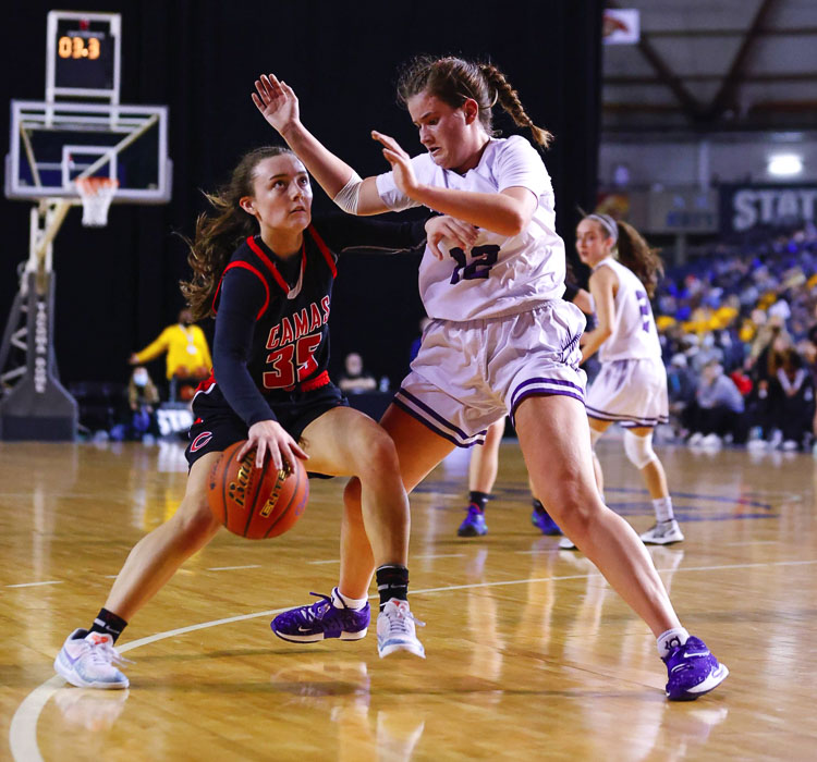 Camas’ Kierra Thompson takes a look up at the clock as she tries to get past Sumner’s Jadey Parrott. Thompson made two 3-pointers in the quarterfinal game. Sumner won in overtime. Photo by Heather Tianen