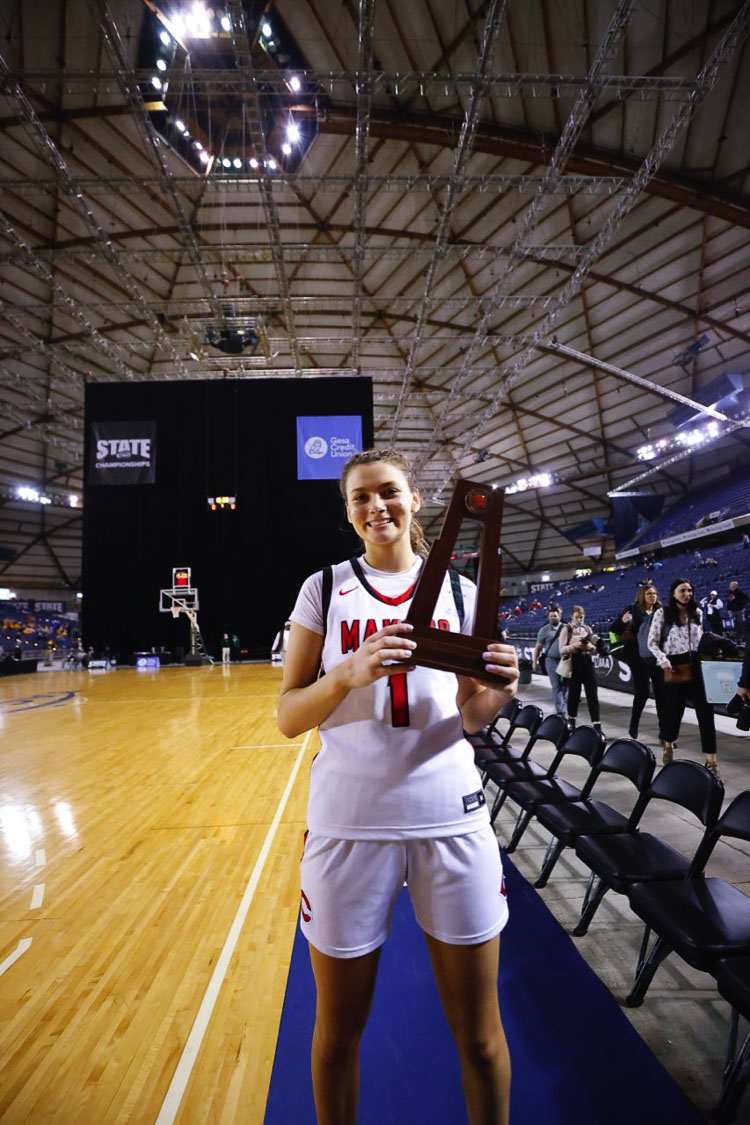 Reagan Jamison of Camas holds up the team’s fourth-place trophy Saturday morning at the Tacoma Dome. Jamison averaged 17.5 points and 11.3 rebounds in her four games in the dome. Photo by Heather Tianen