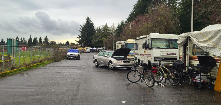 A photo taken last week of a parking lot on city property, used for Alcoa Little League and Fort Vancouver High School athletics, filled with campers and tarps and other items associated with homeless camps. Photo by Paul Valencia