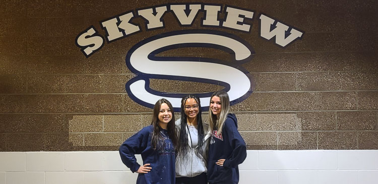 Miriam Kun, Naomi Green, and Rylynn Perdue, students at Skyview High School, helped create Gear for the Globe, an organization that collects baseball and softball equipment to be sent to communities in Africa. Photo by Paul Valencia