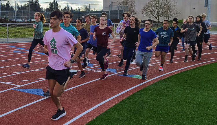 Lorenzo Anguiano takes the lead during a training run with the Evergreen track and field distance runners at a recent practice. An athlete and a musician, Anguiano trains and rehearses every day. Photo by Paul Valencia