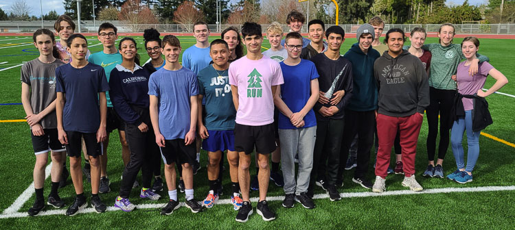 The Evergreen track and field distance runners, with Lorenzo Anguiano in center, have many passions. Several of the runners are musicians. Anguiano plans to study cello performance at Central Washington University.