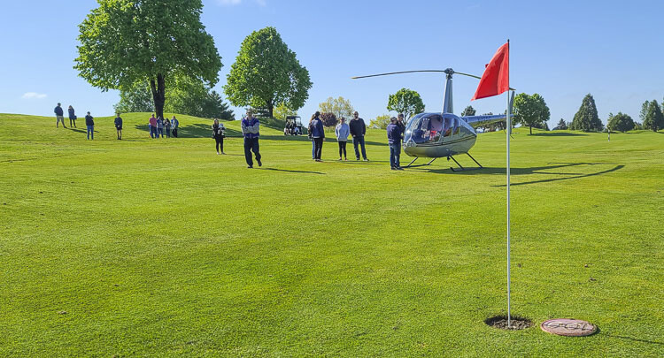 Organizers of the La Center Boosters 2022 Ball Drop Stadium Fundraiser bring golf balls to the helicopter at Tri-Mountain Golf Course on Saturday. The helicopter would “drop” the balls from the sky, with prizes going to the owners of the golf balls closest to a target. Photo by Paul Valencia
