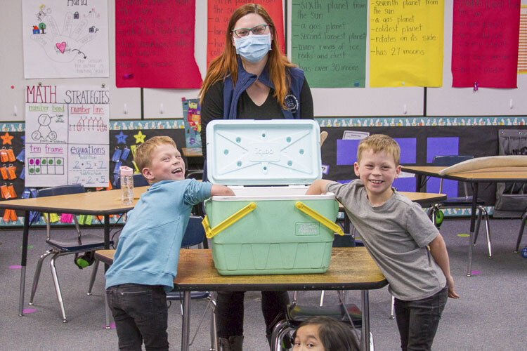 Students conducted an experiment using vegetable shortening and cold water to learn how a whale's blubber insulates the animal against the ocean's cold temperatures. Photo courtesy Woodland School District
