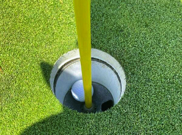 Paige McLean of Union High School was given permission to take a photo of her golf ball in the hole after she record a hole-in-one at the district tournament. Photo courtesy Paige McLean