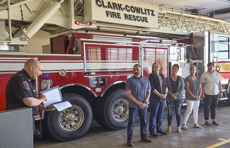 John Nohr, the chief of Clark-Cowlitz Fire Rescue, honors five La Center High School employees with the Fire Chief’s Life Saving Award. Daniel Ruiz, Coral Yee, Denelle Eisland, Denise Yurecko and Sara Rideout all played pivotal roles in saving the life of a student who suffered cardiac arrest last month. Photo by Paul Valencia