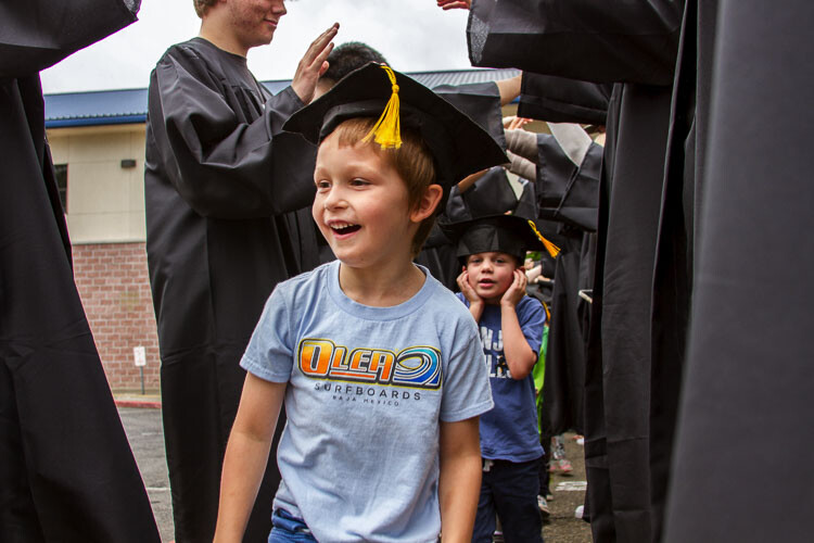 WHS grads formed a Graduation Tunnel for each elementary's kindergartners students to celebrate their transition to 1st grade. Photo courtesy Woodland School District