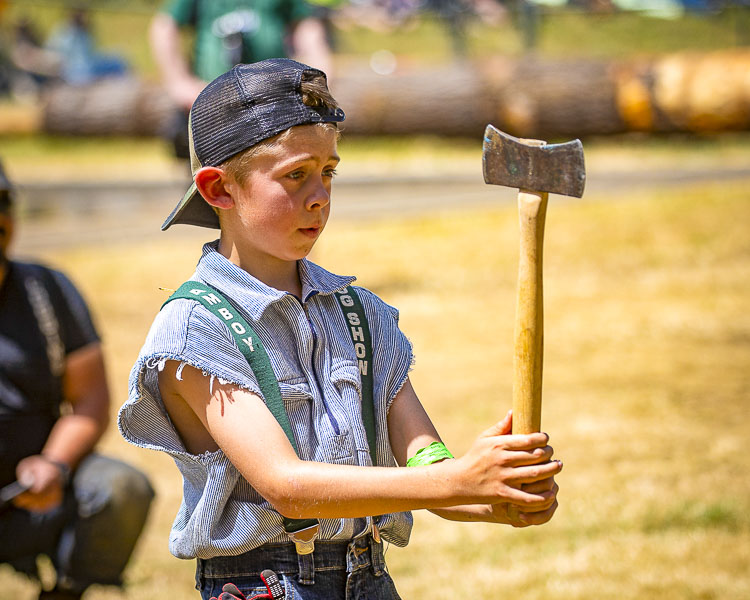 Travin Harris concentrates before his axe throw. Photo by Mike Schultz