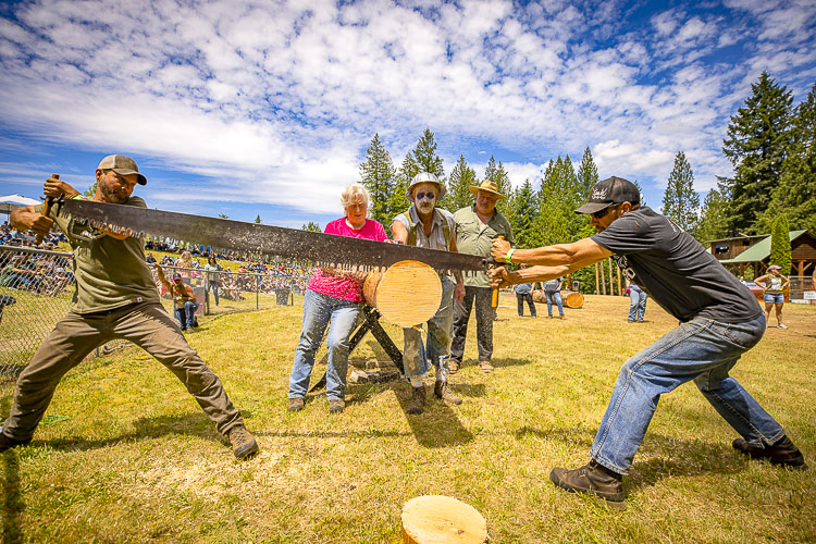 Greg Brown and Aaron Brown team up on the double buck saw. Photo by Mike Schultz