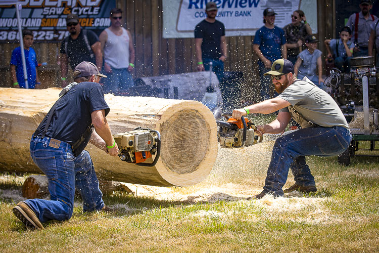 Jeff Fetter Sr. and Arthur Fetter demonstrate the double engine saw. Photo by Mike Schultz