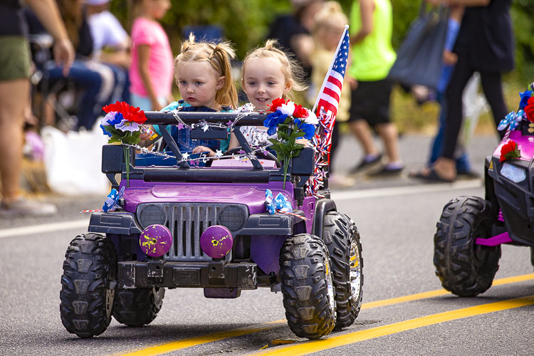 Amberlese and Trinity Rose enjoyed driving and riding in Saturday’s parade. Photo by Mike Schultz