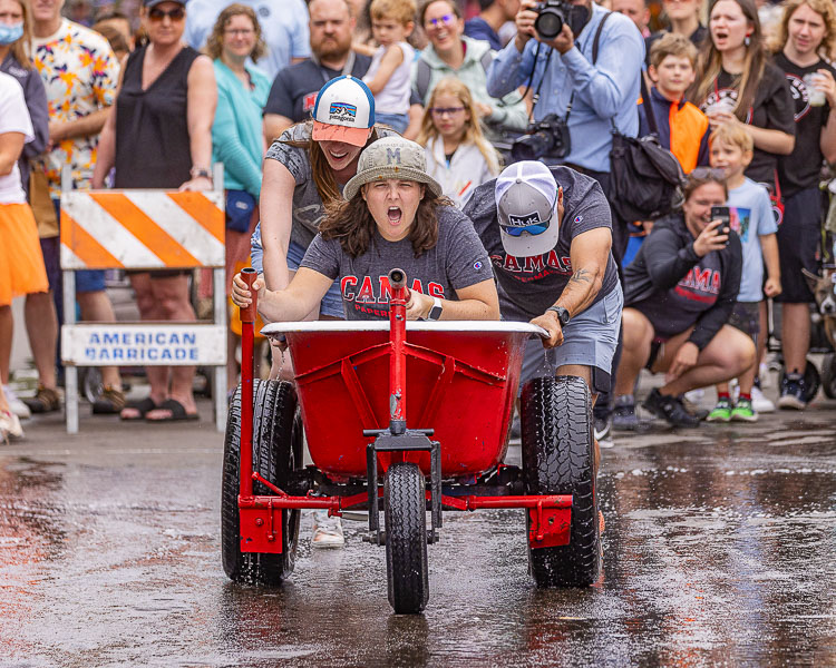 Sam McDowell, Megan Veriha and Lawrence Sylvester participate in the Bathtub Races. Photo by Mike Schultz