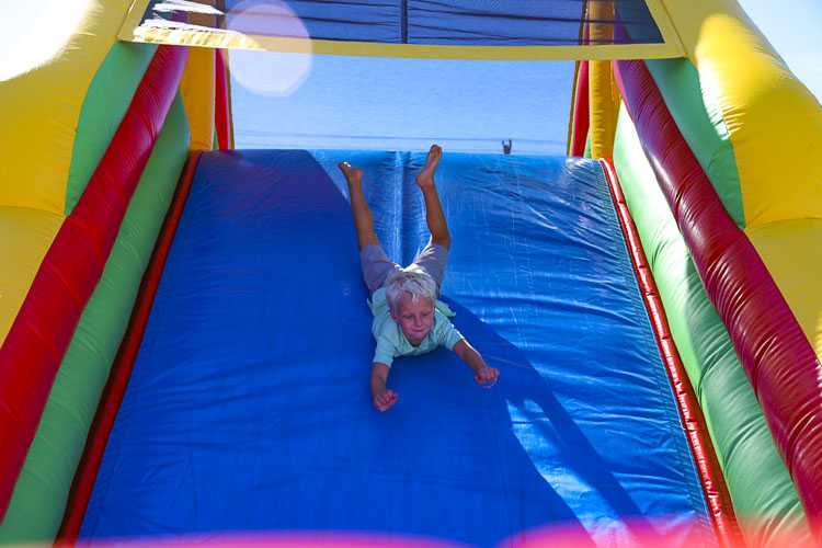 Activities include a game truck, an inflatable bouncy house, a rock climbing wall, face painting, potato sack races, and a selfie photo booth. Photo courtesy Ridgefield School District