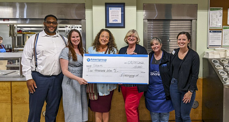 Anthony E. Woods (left) and LeeAnn O’Neil, community engagement specialist, of Amerigroup (third from left) with Share staff members Becci Read-Ryan, Kim Hash, Holley Walhood and Molly Evjen at the July 2022 check presentation. Photo courtesy Share House