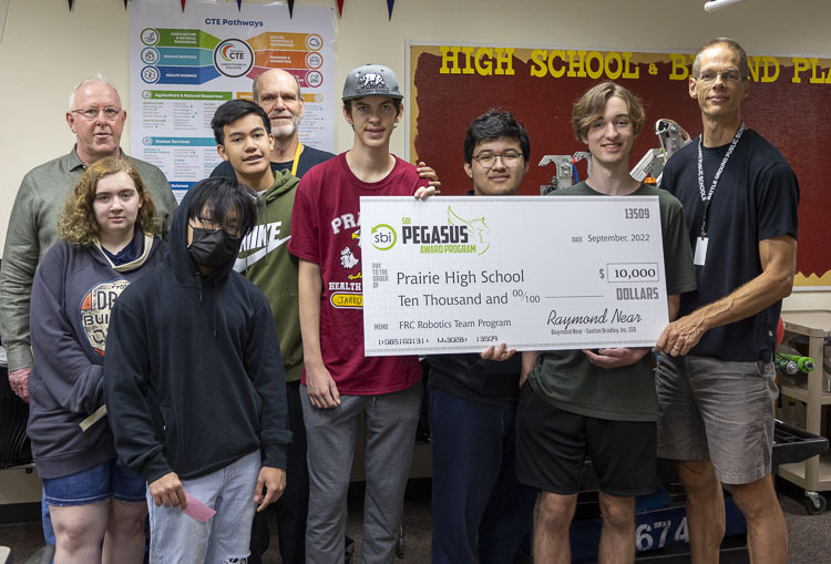 Members of the CloverBots team at Prairie High School pose with Saxton Bradley, Inc. CEO Raymond Near. Photo courtesy Battle Ground School District