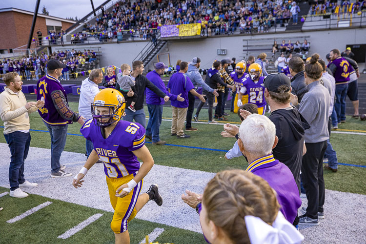 This year’s Columbia River football team ran through a “tunnel” of former players and coaches prior to Friday’s game against Mark Morris. The past paid tribute to their former coach as Vancouver Public Schools officially named the athletic field at Columbia River as John O’Rourke Field. Photo by Mike Schultz