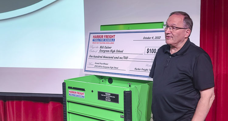 Evergreen High School teacher Bill Culver stands near his check for $100,000 and his “trophy” for winning the Harbor Freight Tools for Schools prize for teaching excellence. The trophy is the tool box. The money will be used by the skilled trade program at Evergreen High School. Photo by Paul Valencia