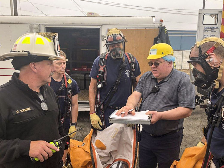 HazMat team members being briefed by plant personnel. Photo courtesy Vancouver Fire Department