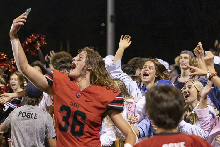 Sam Speer decides that rallying from 19 points down in the fourth quarter to beat Skyview is selfie worthy. Photo by Mike Schultz