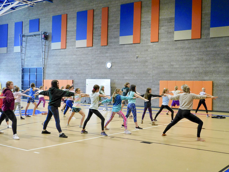 Mandy DeBord of MK Elevate leads the class in a yoga warmup. Photo courtesy Ridgefield School District