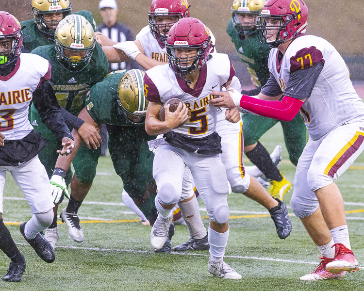 Prairie quarterback Braeden Slamp threw a touchdown pass and ran for one in Prairie’s 13-6 victory over Evergreen. Photo by Mike Schultz