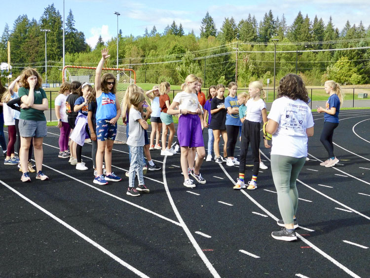 Teacher Anja Felton meets with the girls before they run, jog, or walk the track, working toward their own personal fitness goals. Photo courtesy Ridgefield School District