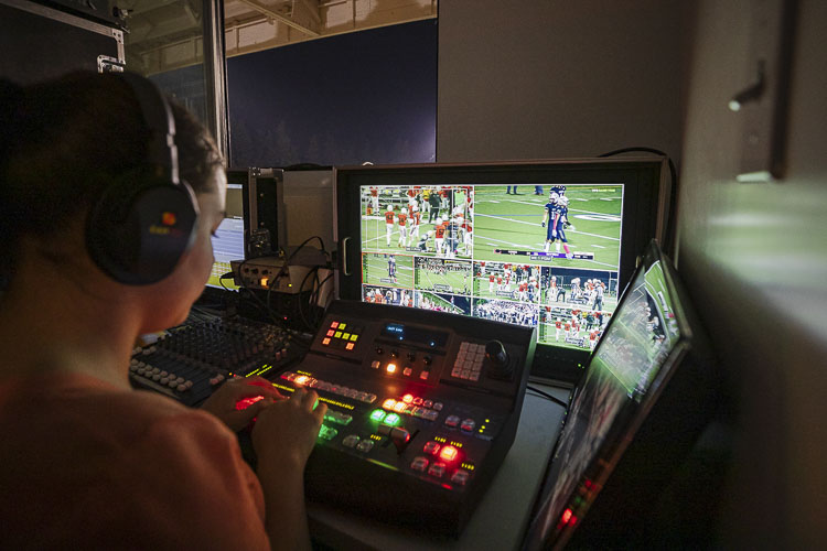 Students direct the broadcast as well, relying on all the technology from the control room at Kiggins Bowl to make the best decisions for the broadcast. Photo by Mike Schultz