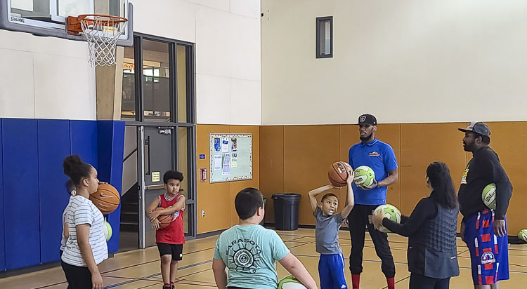 Vancouver Volcanoes coaches and basketball beginners meet on Saturdays at the Marshall Center to go over basketball basics at a clinic. Photo by Paul Valencia