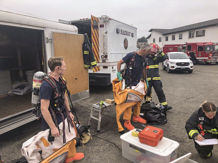 John Mosely (left) and Captain Travis Kent, both Hazardous Materials technicians, prepare to go inside to mitigate the situation. Photo courtesy Vancouver Fire Department