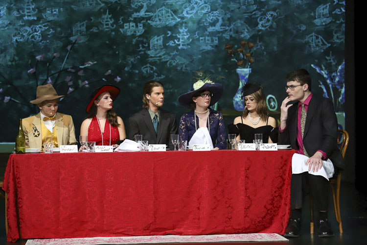 A dangerous dinner with (left to right) BriAnna Robbins as Colonel Mustard, Kaya Felton as Miss Scarlet, Caige Sothern as Mr. Green, Elle Lutz as Mrs. Peacock, Illy Ikonomou as Mrs. White, and Andrew Wilken as Professor Plum. Photo courtesy Ridgefield School District