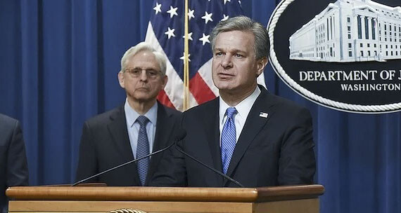 FBI Director Christopher Wray and Attorney General Merrick Garland at a news conference April 6, 2022, announcing a court-authorized disruption of Russian-controlled botnets. Photo courtesy FBI