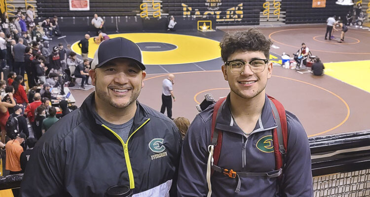 Jake and Jason Wilcox are enjoying their time together at the Pac Coast Wrestling Tournament this week. Jake is the head coach at Evergreen. Jason, a 2021 graduate of Prairie, is on leave from the Air Force and is a volunteer assistant coach for his dad. Photo by Paul Valencia
